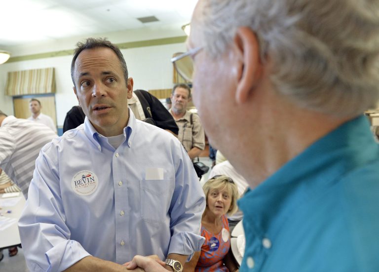 Kentucky Republican Gov. Matt Bevin, left, has since walked back his aim to pull back the program to its original size, saying he may just add in stricter requirements for beneficiaries. (AP Photo/Timothy D. Easley, File)