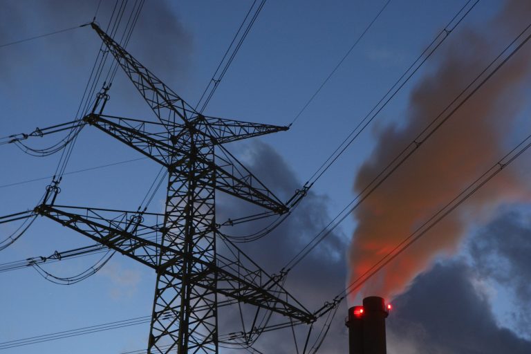 An electricity pylon stands by exhaust pluming from the main chimneys of the coal-fired power plant Heizkraftwerk Reuter West July 31, 2007 in Berlin, Germany. (Photo by Sean Gallup/Getty images)