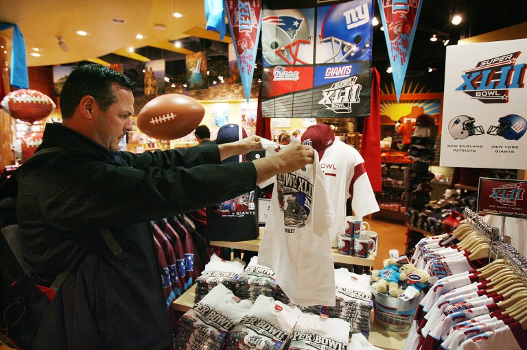 In this Jan. 29, 2008 file photo, Mike San Miguel, of La Verne, Calif., checks out the Super Bowl merchandise in the Arizona Highways retail store at Phoenix Sky Harbor International Airport before catching a flight.  Broadway producers, merchants and restaurateurs may not see the profits they hope will come with the Super Bowl visiting New York as fans will more likely spend their money on NFL branded merchandise and events.  (AP Photo/Ross D. Franklin, File)