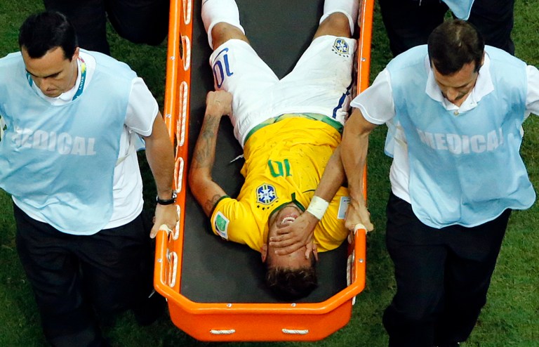 Brazil's Neymar is carried away on a stretcher during the World Cup quarterfinal soccer match between Brazil and Colombia at the Arena Castelao in Fortaleza, Brazil, Friday, July 4, 2014. (AP Photo/Fabrizio Bensch, pool)