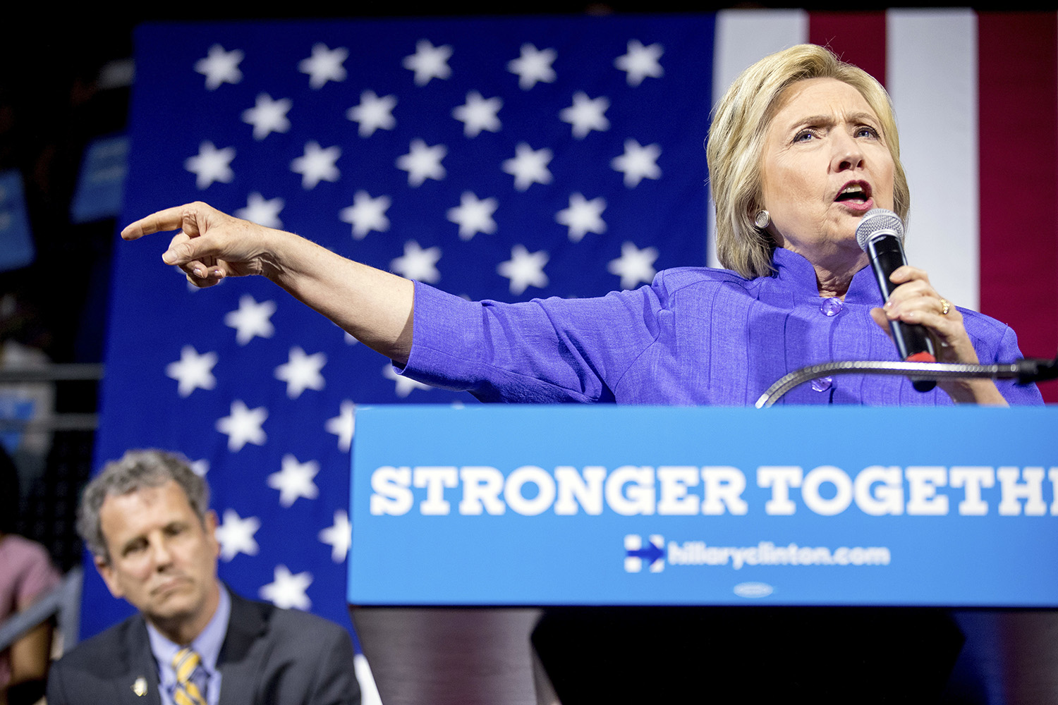 Clinton swings at Trump miles from GOP convention