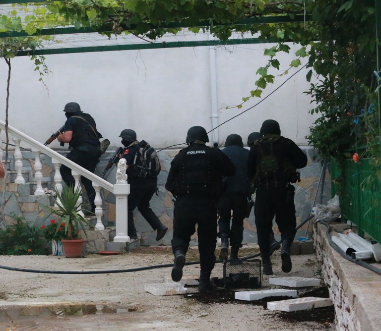 Albanian police comb houses in Lazarat village, 230 kilometers (140 miles) south of capital Tirana, Tuesday, June 17, 2014, looking for cannabis and also suspects who shot at them. Hundreds of Albanian police, backed by armored vehicles, stormed a lawless southern village Monday after suspected marijuana growers allegedly fired rocket-propelled grenades, mortars and machine guns at officers during a drug raid. (AP Photo/Hektor Pustina)
