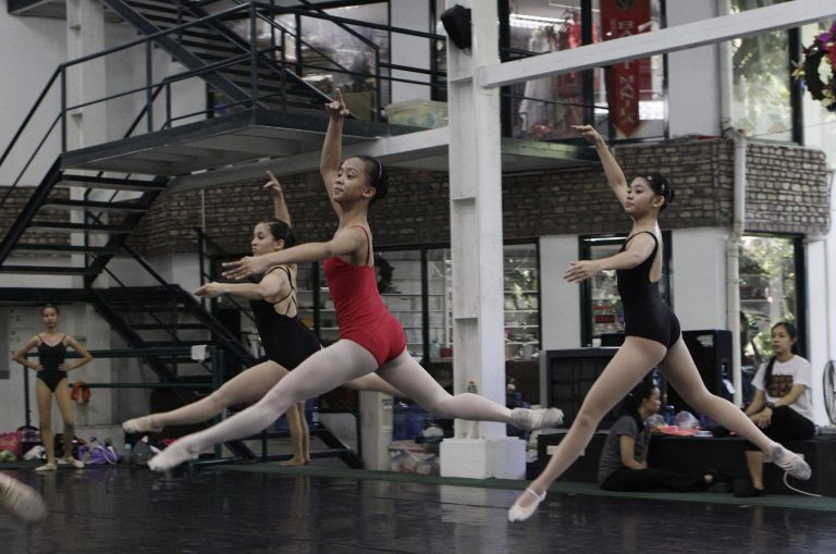   In this photo taken Nov. 25, 2012, Filipino slum dweller Jessa Balote, center, practices with other students during a class at Ballet Manila in the Philippine capital. Balote, who used to tag along with her family as they collect garbage at a nearby dumpsite, is a scholar at Ballet Manila's dance program. As an apprentice, she makes around 7,000 pesos ($170) a month, sometimes double that, from stipend and performance fees. (AP Photo/Aaron Favila)  