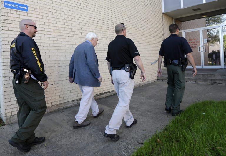 Kaufman county law enforcement officials escort an employee inside the county courthouse Monday, April 1, 2013, in Kaufman, Texas. Law enforcement officials throughout Texas remained on high alert Monday seeking to better protect prosecutors and their staffs following the killing of county district attorney whose assistant was gunned down just months ago. (AP Photo/Tony Gutierrez)(AP Photo/Tony Gutierrez)