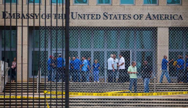 Staff stand within the United States embassy facility in Havana, Cuba, Friday, Sept. 29, 2017. (AP Photo/Desmond Boylan)