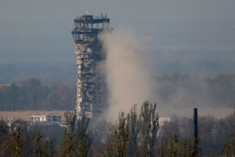 A Ukrainian flag flies over the traffic control tower of Donetsk Sergey Prokofiev International Airport during an artillery battle between pro-Russian rebels and Ukrainian government forces in the town of Donetsk, eastern Ukraine, Friday, Oct. 17, 2014. Ukraine's president on Friday hailed progress in Europe-brokered talks aimed at ensuring peace with Russia, with agreements nearing on a gas dispute and local elections in the east. (AP Photo/Dmitry Lovetsky)