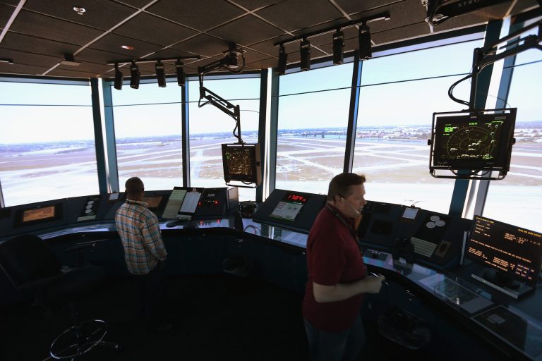 Air Traffic Controller, David Spitnale,(R) and Robert Moreland work in the control tower at Opa-locka airport on March 4, 2013 in Opa-locka, Florida. (Photo by Joe Raedle/Getty images)