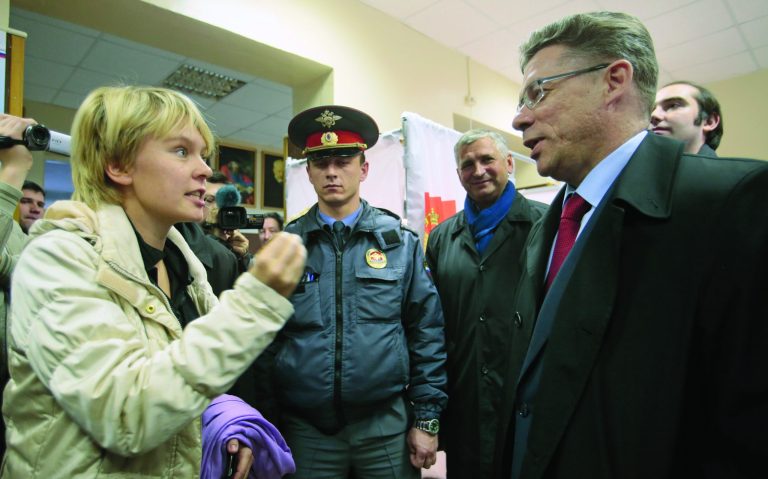 Opposition activist Yevgenia Chirikova, left, speaks to Khimki acting mayor Oleg Shakhov at a polling station in the town of Khimki, outside Moscow, Russia, Sunday, Oct. 14, 2012. Chirikova who played a major role in the massive winter protests against Putin's rule, is challenging the incumbent mayor. She has complained of an uneven playing field, saying authorities tried to thwart her meetings with voters and put up other obstacles. (AP Photo/Mikhail Metzel)