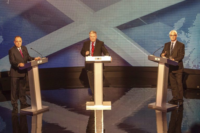 This photo taken and issued on Tuesday Aug. 5, 2014 by Devlin Photo Ltd, shows Scotland's First Minister Alex Salmond, left, Britain's former treasury chief and leader of the pro-Union Better Together campaign Alistair Darling, right, and broadcast journalist Bernard Ponsonby during a televised debate ahead of the referendum on Scottish independence, in Glasgow, Scotland. A second televised debate is to take place on August 25. (AP Photo/PA, Devlin Photo Ltd)