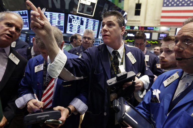 Trader William McInerney, center, works  on the floor of the New York Stock Exchange Friday, April 4, 2014.  Stocks are edging mostly higher in early trading Friday after the government reported that U.S. employers added to their payrolls last month. (AP Photo/Richard Drew)