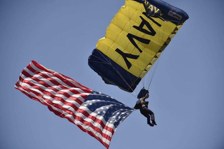 A member of the Navy Seals parachute team lands on the field before a baseball game between at Petco Park in San Diego,Â May 25, 2014. A similar descent took place to honor the fallen Navy SEALS and Army Special Forces in Suffolk on Saturday. (Getty File Photo)