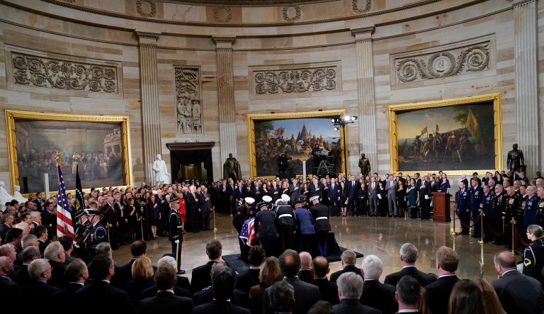 The flag-draped casket of former President George H.W. Bush is carried by joint services military honor guard into the Capitol in Washington, Monday, Dec. 3, 2018. 