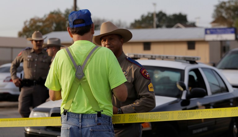 A man talks with a law enforcement official at the scene of a shooting at the First Baptist Church of Sutherland Springs, Monday, Nov. 6, 2017, in Sutherland Springs, Texas. A man opened fire inside the church in the small South Texas community on Sunday, killing and wounding many. (AP Photo/Eric Gay)