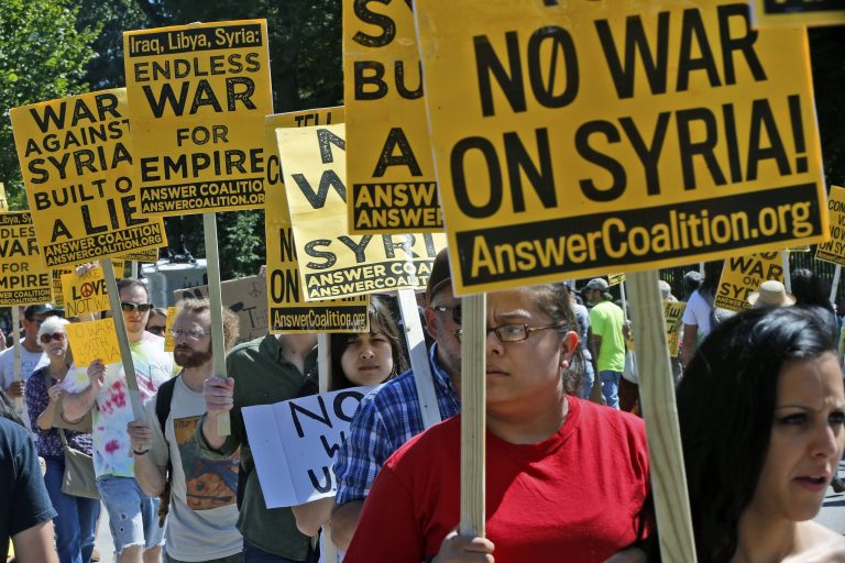   Anti-war demonstrators in Washington protest against possible U.S. military action in Syria in front of the White House Saturday, Sept. 7, 2013. (AP Photo/Charles Dharapak)  