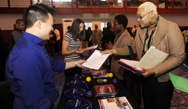 FILE - In this April 23, 2014 file photo, Luke Gill, left,  of Quicken Loans, talks with job candidate Jasmine Boykins at a job fair at the Matrix Center in Detroit. The Conference Board releases the Consumer Confidence Index for April on Tuesday, April 29, 2014. (AP Photo/The Detroit News, David Coates, File)