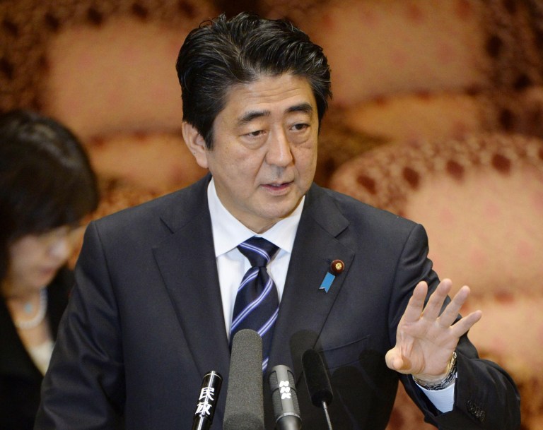 Japanese Prime Minister Shinzo Abe gives an answer during a meeting of the Upper House Budget Committee in Tokyo Friday, March 14, 2014. Abe said his government is not considering a revision of the country's 1993 apology for forcing South Korean and other women to have sex with Japanese soldiers during World War II. (AP Photo/Kyodo News) JAPAN OUT, MANDATORY CREDIT