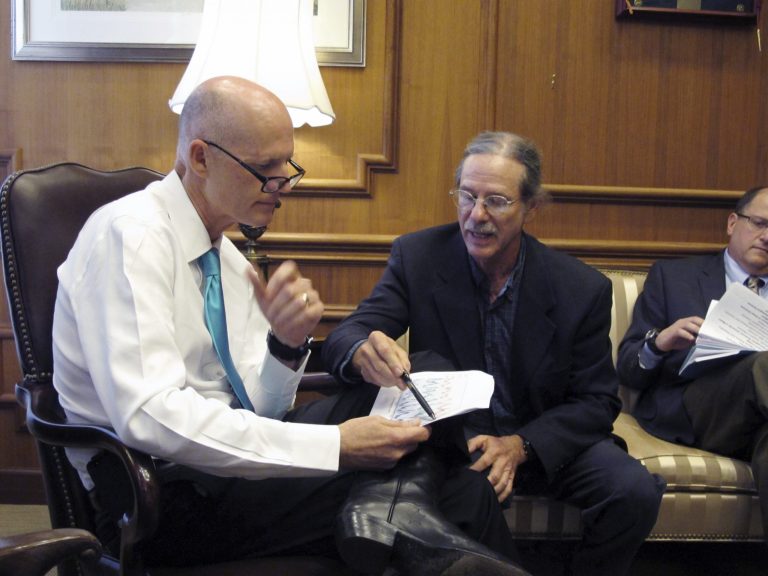 Florida State University environmental science professor Jeffrey Chanton gives a presentation to Florida Gov. Rick Scott, left, on climate change on Tuesday in Tallahassee, Fla. (AP Photos/Brendan Farrington)