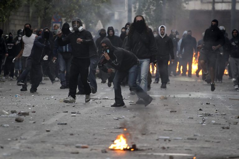 Protesters throw stones at riot police during rioting over austerity measures in central Athens, Thursday, Oct. 20, 2011. (AP Photo/Petros Giannakouris)