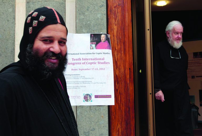 A Coptic and a catholic priest, right, walk outside the Augustinianum institute where an international congress on Coptic studies is held in Rome, Wednesday, Sept. 19, 2012. Scholars are questioning the authenticity and significance of a much-publicized discovery by a Harvard scholar who reported that a 4th Century fragment of papyrus has provided the first evidence that some early Christians believed Jesus was married. Karen King, a professor at Harvard Divinity School, announced the finding Tuesday at an international congress on Coptic studies in Rome. (AP Photo/Gregorio Borgia)