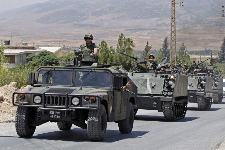 FILE -- In this Aug. 4, 2014, file photo, Lebanese army reinforcements arrive to the outskirts of Arsal, a predominantly Sunni Muslim town near the Syrian border in eastern Lebanon. Lebanese security officials say attackers fired a rocket at an army patrol near the Syrian border, killing two soldiers and wounding many. The rocket hit Friday, Sept. 19, 2014 near the army patrol outside the border town of Arsal, an area of repeated clashes, the security officials said, speaking on condition of anonymity in line with regulations. (AP Photo/Bilal Hussein, File)