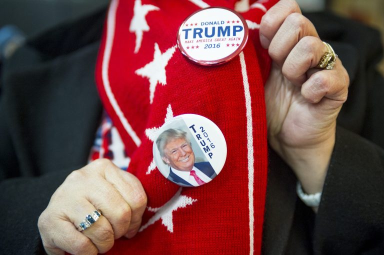 Donna Niemaszyk, a self described 'Trumpie' from New Hampshire, displays her Trump buttons before a Donald Trump campaign rally at Stevens High School on Jan. 5 in Claremont, New Hampshire. (Christian Science Monitor via AP)