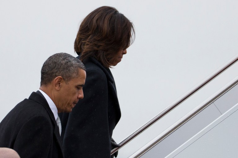 President Barack Obama and first lady Michelle Obama board Air Force One to travel to South Africa for a memorial service in honor of Nelson Mandela on Monday, Dec. 9, 2013 in Andrews Air Force Base, Md. (AP Photo/ Evan Vucci)