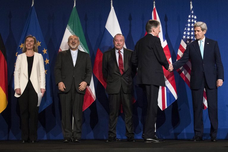 From left, European Union High Representative for Foreign Affairs and Security Policy Federica Mogherini, Iranian Foreign Minister Javad Zarifat, an unidentified Russian official, look on as British Foreign Secretary Philip Hammond shakes hands with US Secretary of State John Kerry as they arrive at the Swiss Federal Institute of Technology, or Ecole Polytechnique Federale De Lausanne, in Lausanne, Switzerland, Thursday, April 2, 2015, after Iran nuclear program talks finished with extended sessions. (AP Photo/Brendan Smialowski, Pool)