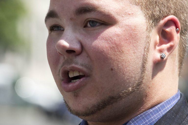 Bryan Ellicott speaks at a news conference in front of State Supreme Court, Tuesday, June 3, 2014 in New York. The transgender man has sued New York City after he says he was booted from a male locker room at a public pool in Staten Island. He says a staff member ordered him to use the women's locker room. (AP Photo/Mark Lennihan)