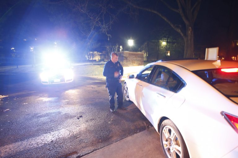 An American University officer turns a motorist away from the Fletcher Gate A entrance to American Universityon Wednesday night, Dec. 11, 2013, in Washington. The campus in the city's northwest section went on lockdown just before 8 p.m. following a report of a man with a gun. (AP Photo/Alex Brandon)