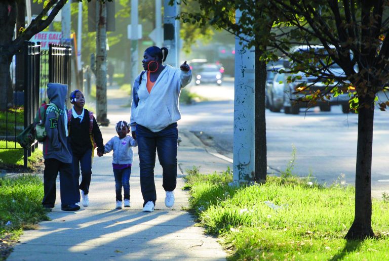 Leslie Sabbs-Kizer, right, walks her children Nkai Melton, 8, Akaira Melton, 7, and Khaymya Smith, 3 to Bond Elementary school in Chicago, Wednesday morning, Sept. 19, 2012, after Chicago teachers voted to suspend their first strike in 25 years. Union delegates voted overwhelmingly Tuesday night to suspend the walkout after discussing a proposed contract settlement with the nation's third largest school district. (AP Photo/M. Spencer Green)