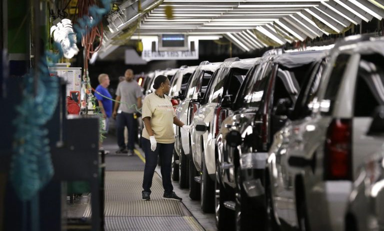 FILE - In this May 13, 2014 file photo, an auto worker inspects finished SUVs coming off the assembly line at the General Motors auto plant in Arlington, Texas. As General Motors tackles a safety crisis, a look at its numbers from June show just how intent the company is on keeping new-car sales on the rise during a record spate of safety recalls.  (AP Photo/LM Otero, File)