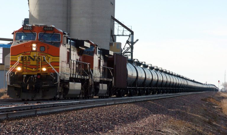 FILE - In this Nov. 6, 2013, file photo, a BNSF Railway train hauls crude oil near Wolf Point, Mont. The oil industry's lead trade group released new standards on Thursday, Sept. 25, 2014, for testing and classifying crude shipped by rail after prior shipments were misclassified, including a train that derailed in Canada and killed 47 people. Shipping oil by rail has become far more common as domestic drilling booms in North Dakota, Montana, Texas, Colorado and other states.  (AP Photo/Matthew Brown, File)
