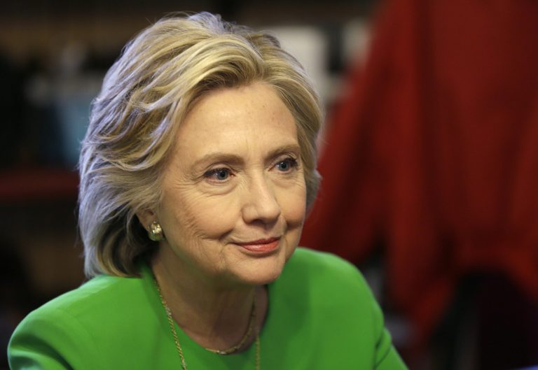 IN this April 14, 2015, photo, Democratic presidential candidate Hillary Rodham Clinton meets with local residents at the Jones St. Java House in LeClaire, Iowa. (AP Photo/Charlie Neibergall)