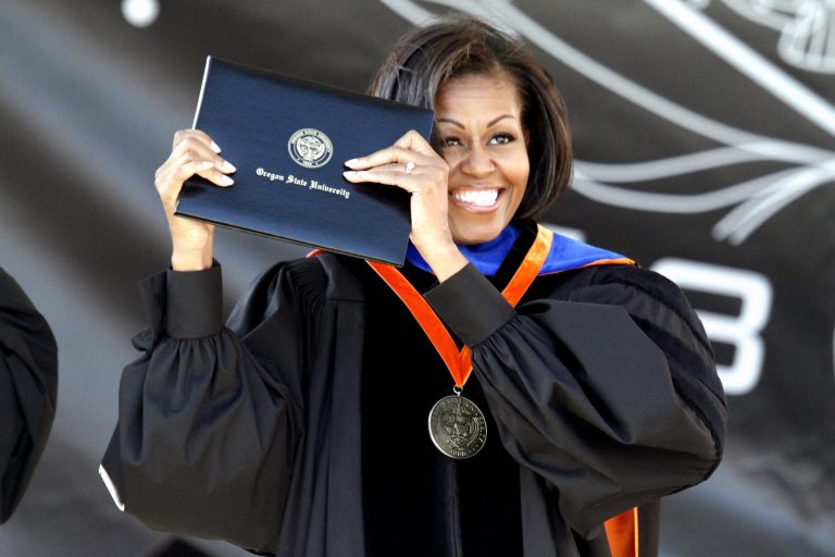   First Lady Michelle Obama holds up her diploma after receiving an honorary degree during the Oregon State University graduation ceremony in Corvallis, Ore., Sunday June 17, 2012. The First Lady gave the commencement address at Oregon State University, the school where her brother is the head basketball coach. (AP Photo/Don Ryan)  