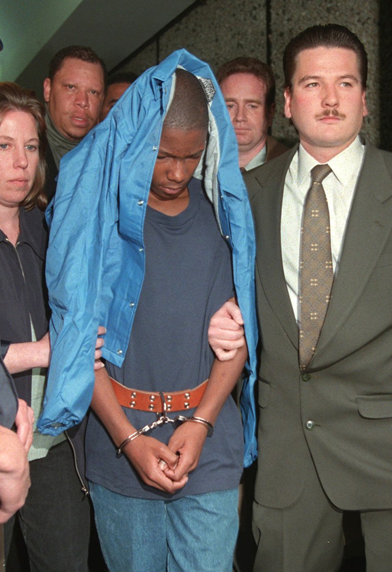 FILE - In this June 3, 1997 file photo, Malcolm Shabazz, 12, is led from family court in Yonkers, N.Y., in connection with the death of his grandmother, Betty Shabazz, the widow of political activist Malcolm X. U.S. officials say Malcolm Shabazz was killed Thursday, May 10, 2013 in Mexico City. (AP Photo/Kathy Willens, File)
