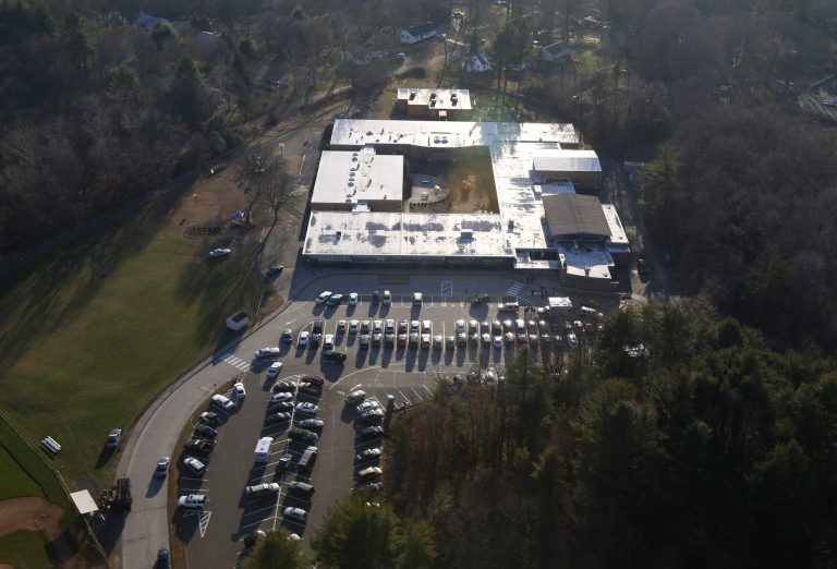   This aerial photo shows Sandy Hook Elementary School in Newtown, Conn. where authorities say a gunman opened fire in a shooting that left 27 people dead, including 20 children, Friday, Dec. 14, 2012. (AP Photo/Julio Cortez)  