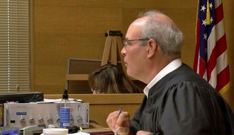 A gunman ambushed a judge outside his Ohio courthouse, and the judge returned fire with a probation officer, killing the attacker. The judge, Joseph J. Bruzzese Jr., was taken into surgery and expected to survive the Monday shooting attack. (WTOV-TV via AP)