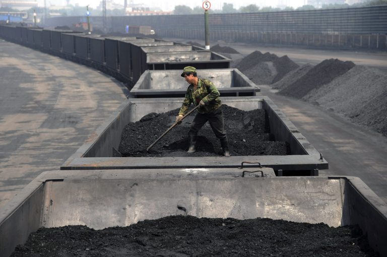 FILE - In this Wednesday, July 31, 2013, file photo, a worker levels the coal on a freight train in Taiyuan in northern China's Shanxi province. Spurred chiefly by China, the United States and India, the world spewed far more carbon pollution into the air last year than ever before, scientists announced Sunday, Sept. 21, 2014, as world leaders gather to discuss how to reduce heat-trapping gases.  (AP Photo/File) CHINA OUT