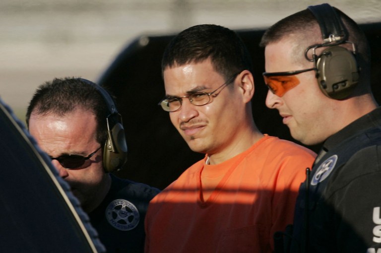   FILE - In this Jan. 5, 2006 file photo, Jose Padilla, center, is escorted to a waiting police vehicle by federal marshals near downtown Miami. The American Civil Liberties Union says it will ask the OAS' human rights commission to investigate the U.S. government for allegedly violating the rights of convicted terrorism plotter Jose Padilla by labeling him an 