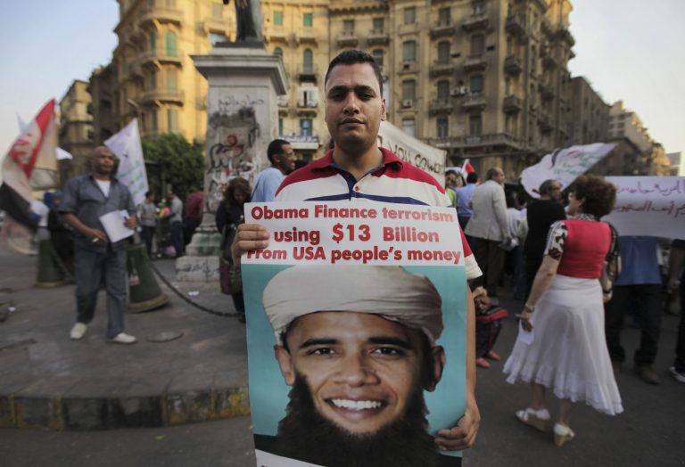 A demonstrator holds a placard mocking President Obama during a protest against possible U.S. forces' strike in Syria, in Cairo, Egypt, on Sunday. (AP/Lefteris Pitarakis)