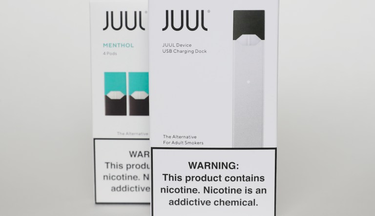 FILE - This Tuesday, Feb. 25, 2020 file photo shows packaging for an electronic cigarette and menthol pods from Juul Labs, in Pembroke Pines, Fla. The FDA is expected to announce a ban on Juul products in the U.S. following years of investigation into the company's role in perpetuating a teen vaping epidemic. (AP Photo/Brynn Anderson)