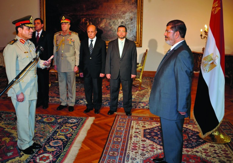 RETRANSMISSION FOR ALTERNATIVE CROP - Egyptian President Mohammed Morsi swears in newly-appointed Minister of Defense, Lt. Gen. Abdel-Fattah el-Sissi, in Cairo, Egypt, Sunday, Aug. 12, 2012. Egypt's Islamist president ordered his former defense minister and chief of staff to retire on Sunday and canceled the military-declared constitutional amendments that gave top generals wide powers. (AP Photo/Egyptian Presidency)