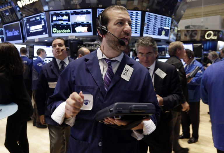Trader Greg Mulligan, center, works on the floor of the New York Stock Exchange Monday, June 9, 2014. The stock market nudged higher Monday morning after a handful of U.S. companies announced acquisitions. Family Dollar's stock jumped following news that investor Carl Icahn has taken a stake in the company. (AP Photo/Richard Drew)