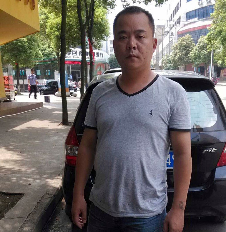 HOLD FOR STORY CHINA COLLECTIVE COERCION BY DIDI TANG In this photo taken Friday, Aug 29, 2014 and released by Xiao Yong, Xiao Yong poses for a photo in Wugang county in central China's Hunan province. Xiao Yong used to hold up placards to demand that Chinaâs leaders declare their assets, but the 39-year-old withdrew from all activism last year when men started following his father around.  (AP Photo/Xiao Yong)