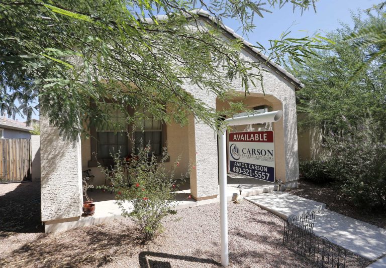   FILE - In this Tuesday, July 30, 2013, file photo, a realty sign hangs in front of a home for sale in Gilbert, Ariz. Standard & Poor's/Case-Shiller reports on home prices in July on Tuesday, Sept. 24, 2013. (AP Photo/Matt York, File)  