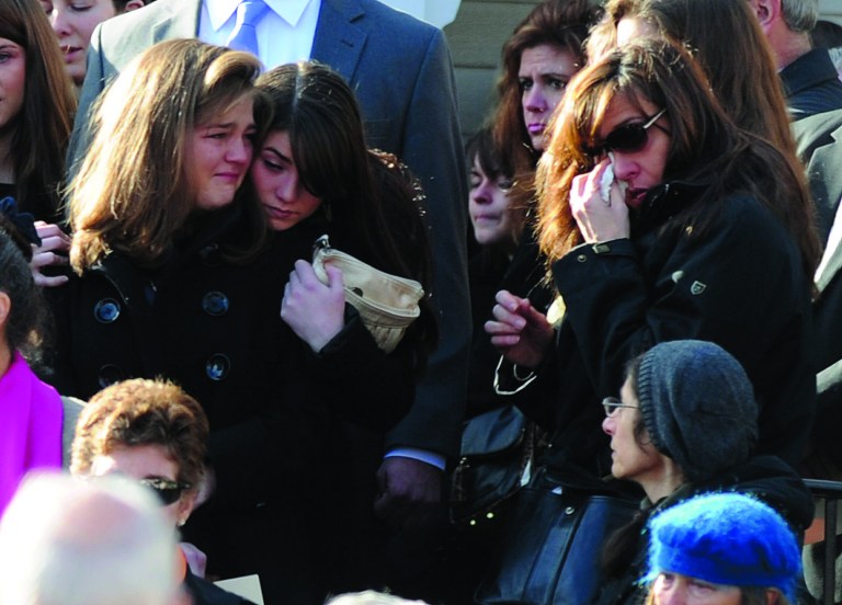 Mourners exit St. Mary Of The Assumption Church in Katonah, N.Y. after the funeral for Anne Marie Murphy on Thursday, Dec. 20, 2012. Murphy was killed when Adam Lanza, walked into Sandy Hook Elementary School in Newtown, Conn., Dec. 14, and opened fire, killing 26, including 20 children, before killing himself. (AP Photo/The Stamford Advocate, Lindsay Niegelberg) MANDATORY CREDIT