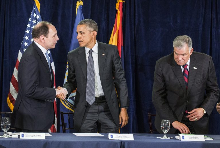 President Obama, center, shakes hands with Secretary of Veterans Affairs Bob McDonald, left, as former USAA CEO Josue Robles appears at right, Friday, March 13, 2015, in Phoenix. (AP Photo/The Arizona Republic, Nick Oza)