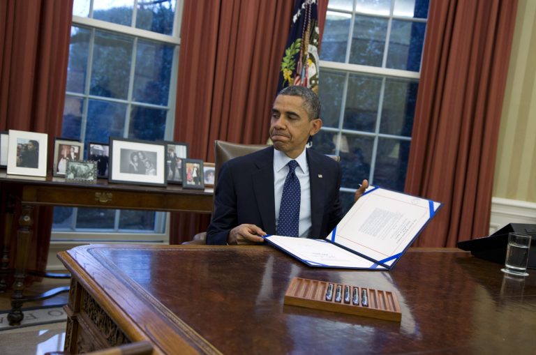President Barack Obama closes a folder after signing the last of three bills in the Oval Office of the White House on Wednesday, Nov. 27, 2013 in Washington. According to the White House release, President Obama signed S. 252 : Prematurity Research Expansion and Education for Mothers who deliver Infants Early Reauthorization Act or the 