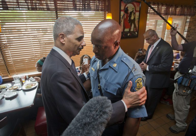 Attorney General Eric Holder greets Capt. Ron Johnson of the Missouri State Highway Patrol at Drake's Place Restaurant, Wednesday, Aug. 20, 2014, in Ferguson, Mo. (AP Photo/Pablo Martinez Monsivais, Pool)