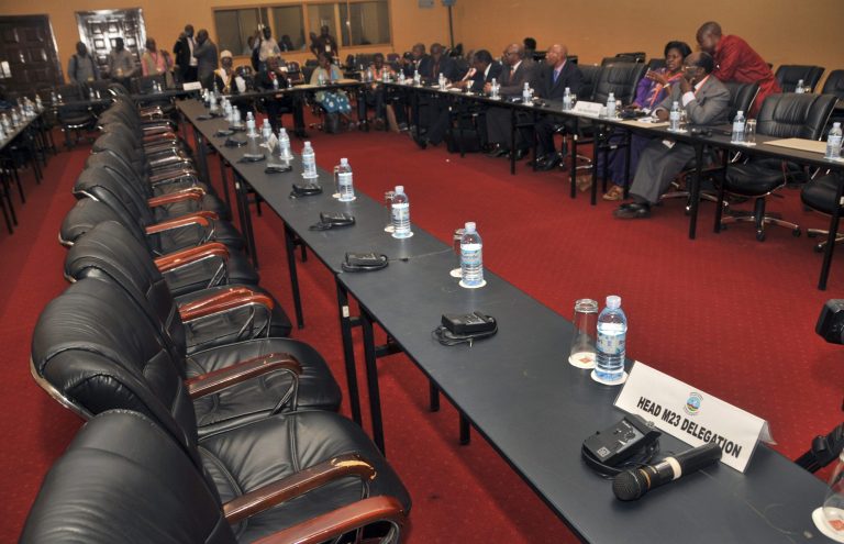   The Congolese government delegation, right, sits opposite a row of empty seats intended for the delegation of Congolese M23 rebels, who did not turn up for the crucial meeting, at peace talks being held in Kampala, Uganda Monday, Dec. 10, 2012. Representatives of rebels attending peace talks with the Congolese government dodged a crucial meeting Monday at which the government delegation was to respond to earlier criticism, a development that could jeopardize negotiations to end the crisis in eastern Congo. (AP Photo/Stephen Wandera)  
